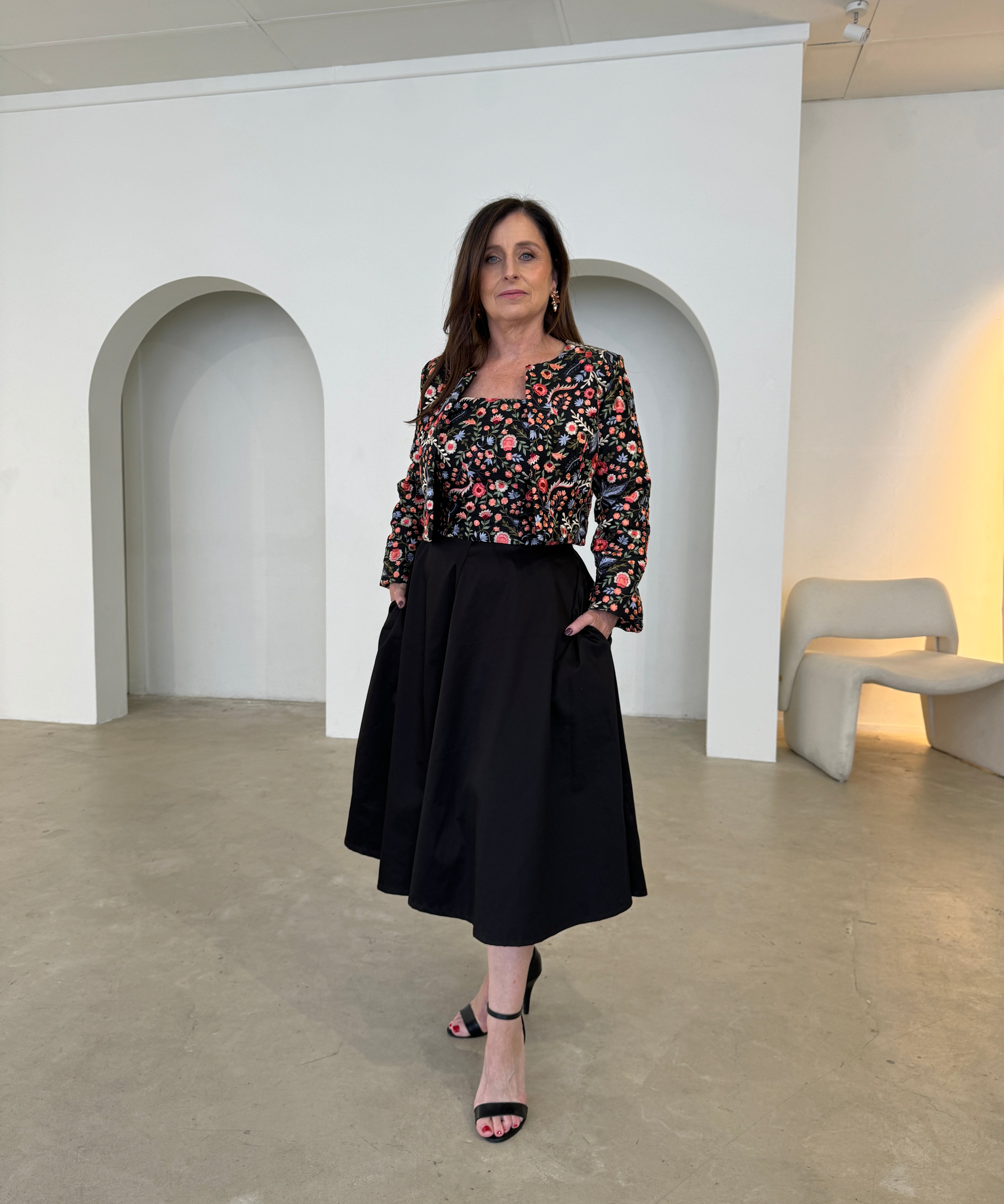 Black, floral, strapless gown with matching short, bolero long sleeve jacket.