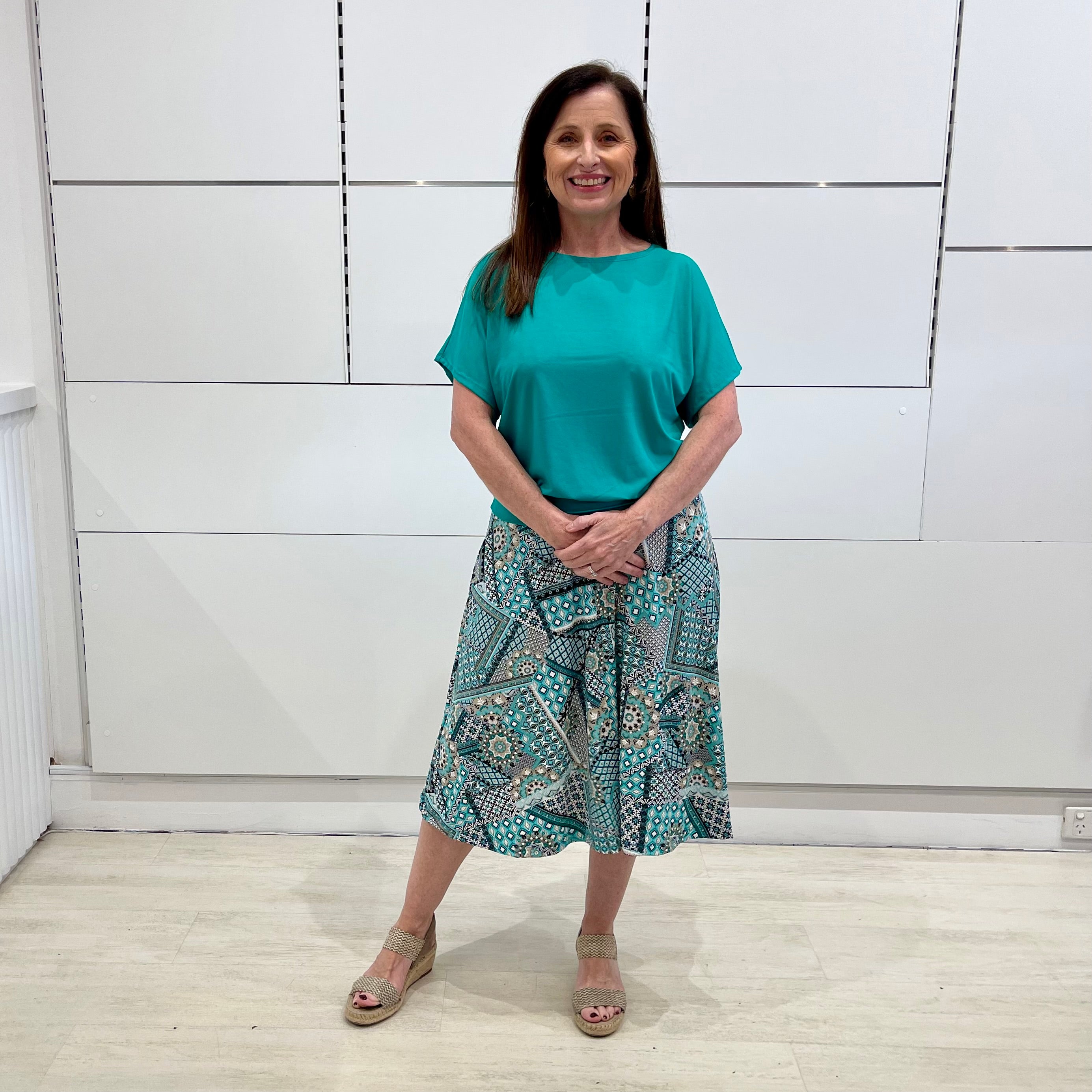Green print, midi length, A line skirt, with stretch waistband. Worn with short sleeve, relaxed fit, green bamboo top.