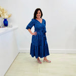 Sapphire background with a deep teal and black very discreet and discerning animal print. V-neck. Gathered sleeve at the shoulder. Roomy Sleeves that can be worn at long sleeves or three quarters. Cuffed at the wrist with discreet elastic threaded through. 7/8s in length. Two tier skirt. Lower tier with a subtle ruffle. Fitted at the waist with elastic threaded through the back discreetly for comfort and ease of getting on. Sash worn on waist. Centre back zipper.