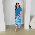 Turquoise blue bamboo, short sleeve, cowl neckline top, with midi length floral skirt.