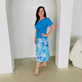 Turquoise blue bamboo, short sleeve, cowl neckline top, with midi length floral skirt.
