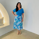 Turquoise blue bamboo, short sleeve, cowl neckline top, with midi length floral skirt.