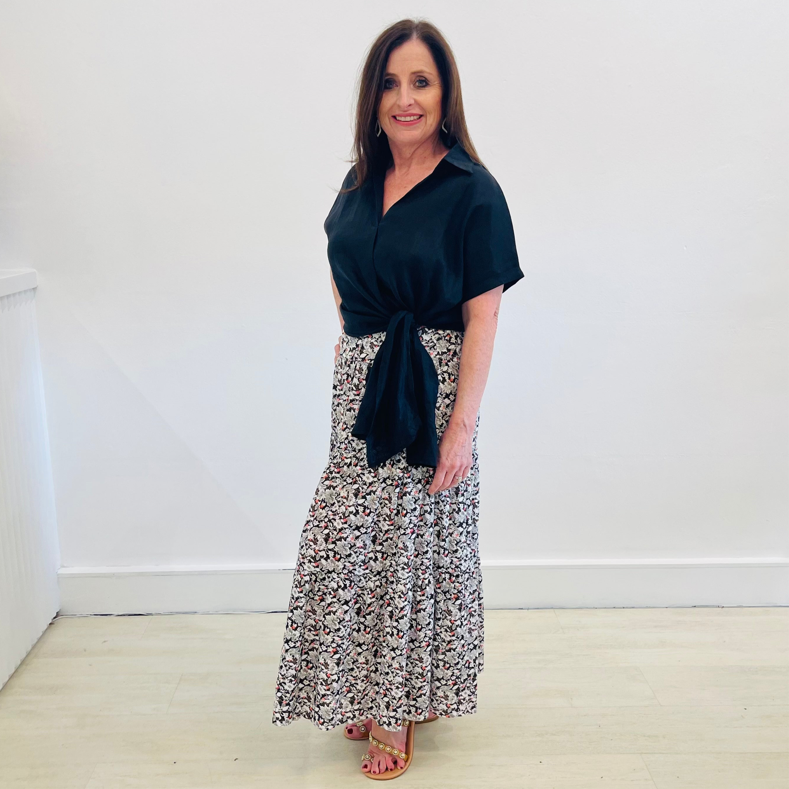 Maxi, long, tiered skirt in a black, white & red pattern print, worn with short sleeve, side tie on waistline, v neckline,collared, women's, linen shirt