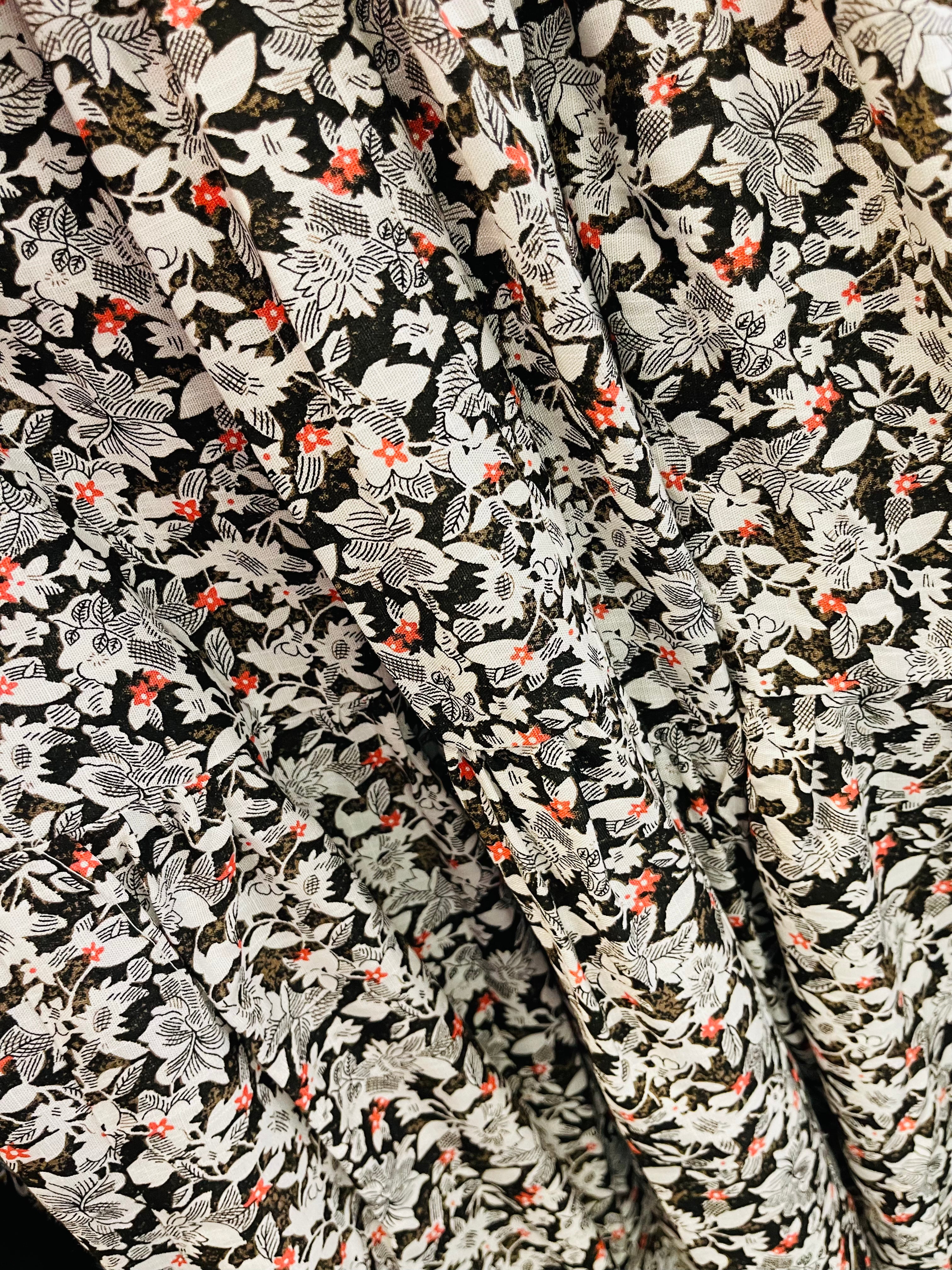 100% linen with a White, black and red delicate flower print tiered skirt flat waistband with elastic through the bac