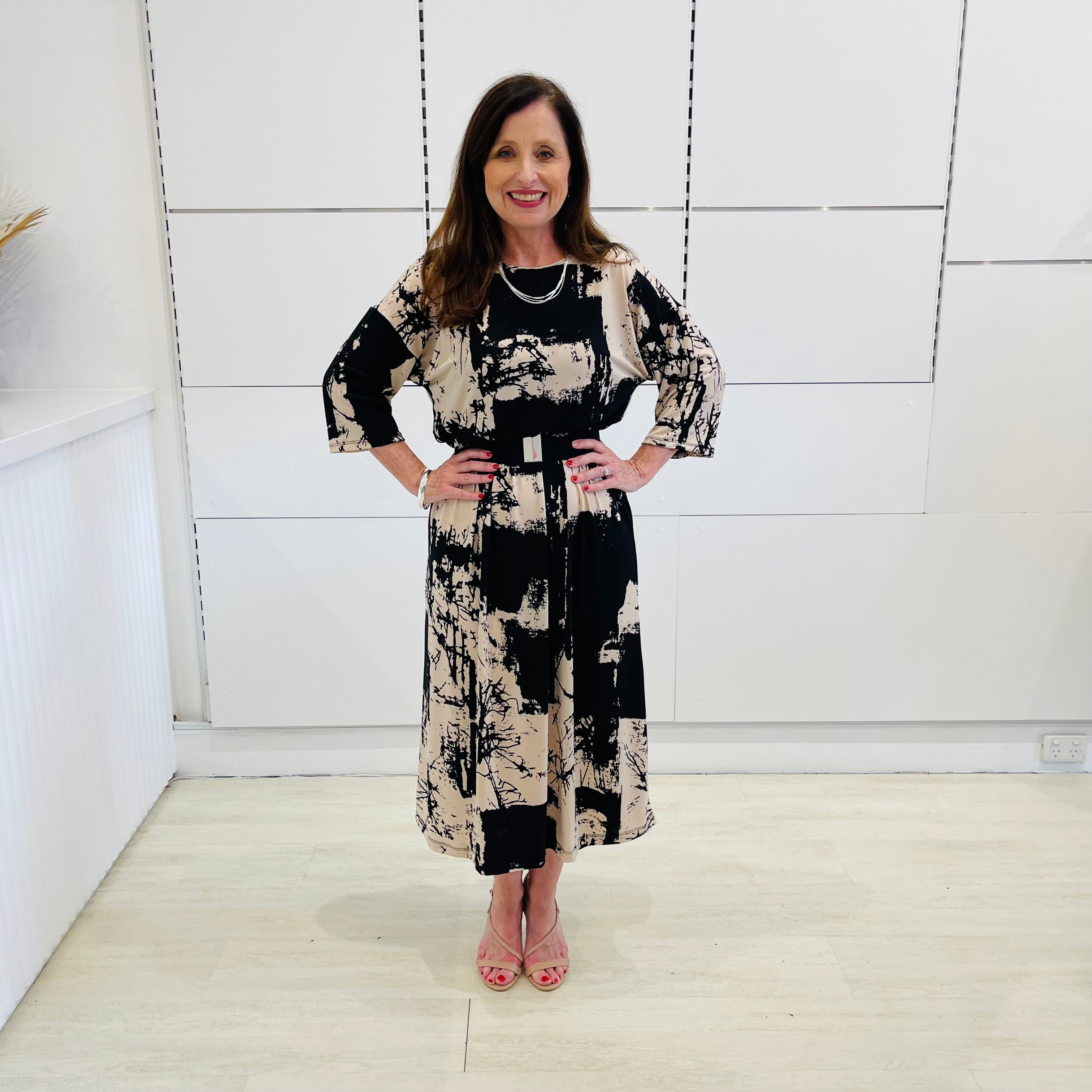 Black and beige print, 3/4 sleeve, midi length dress for special event wear.