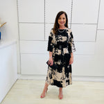 Relaxed fit evening dress. Black and beige print, 3/4 sleeve, midi length dress for special event wear.