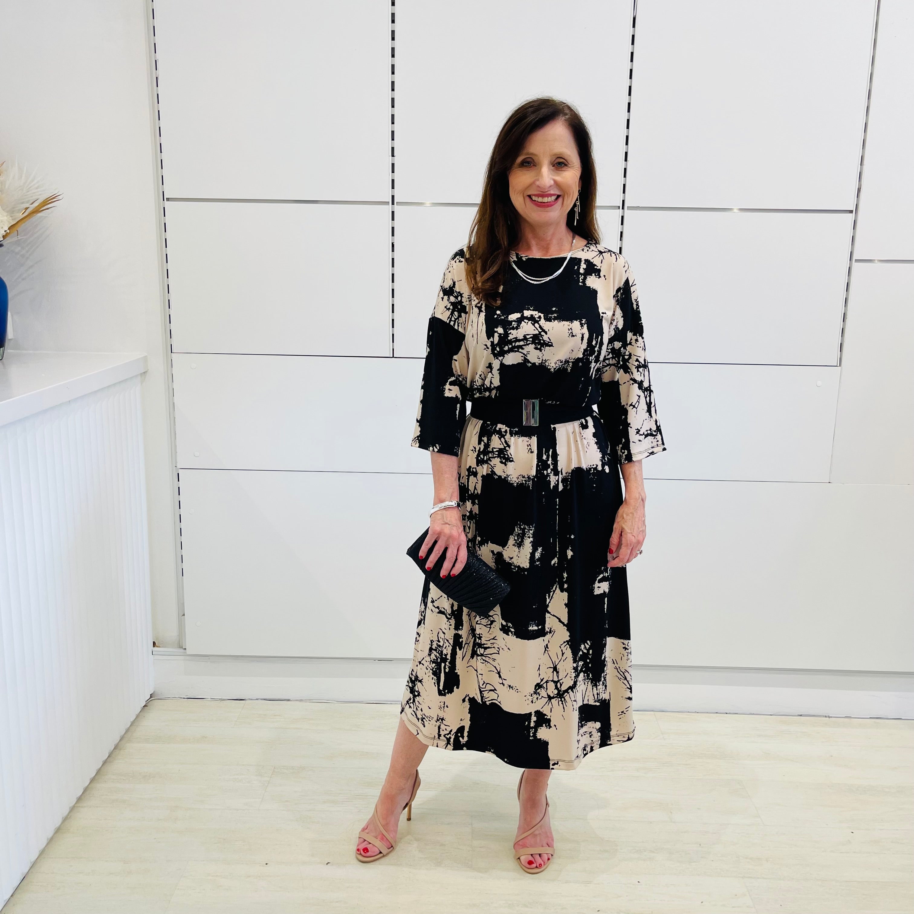 Relaxed fit evening dress. Black and beige print, 3/4 sleeve, midi length dress for special event wear.