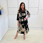Black and beige print, midi length, 3/4 sleeve, relaxed fit dress for special event wear.