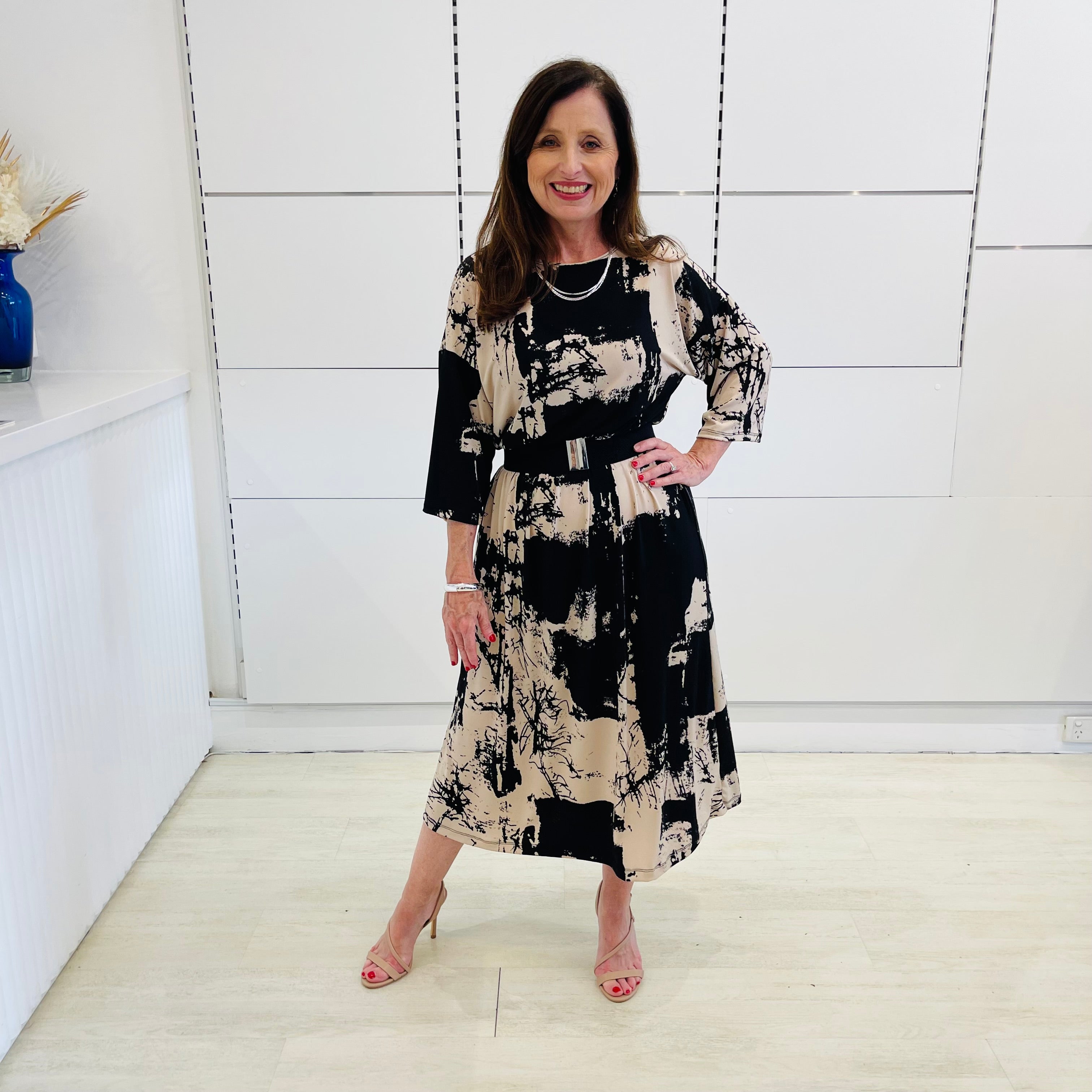 Black and beige print, midi length, 3/4 sleeve, relaxed fit dress for special event wear.