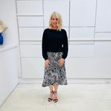 Noir garden-Black and white floral print, Rachel  Ruffle skirt, with elastic stretch waist. Worn on model with black bamboo , long sleeve,  round neckline, Gracie top.
