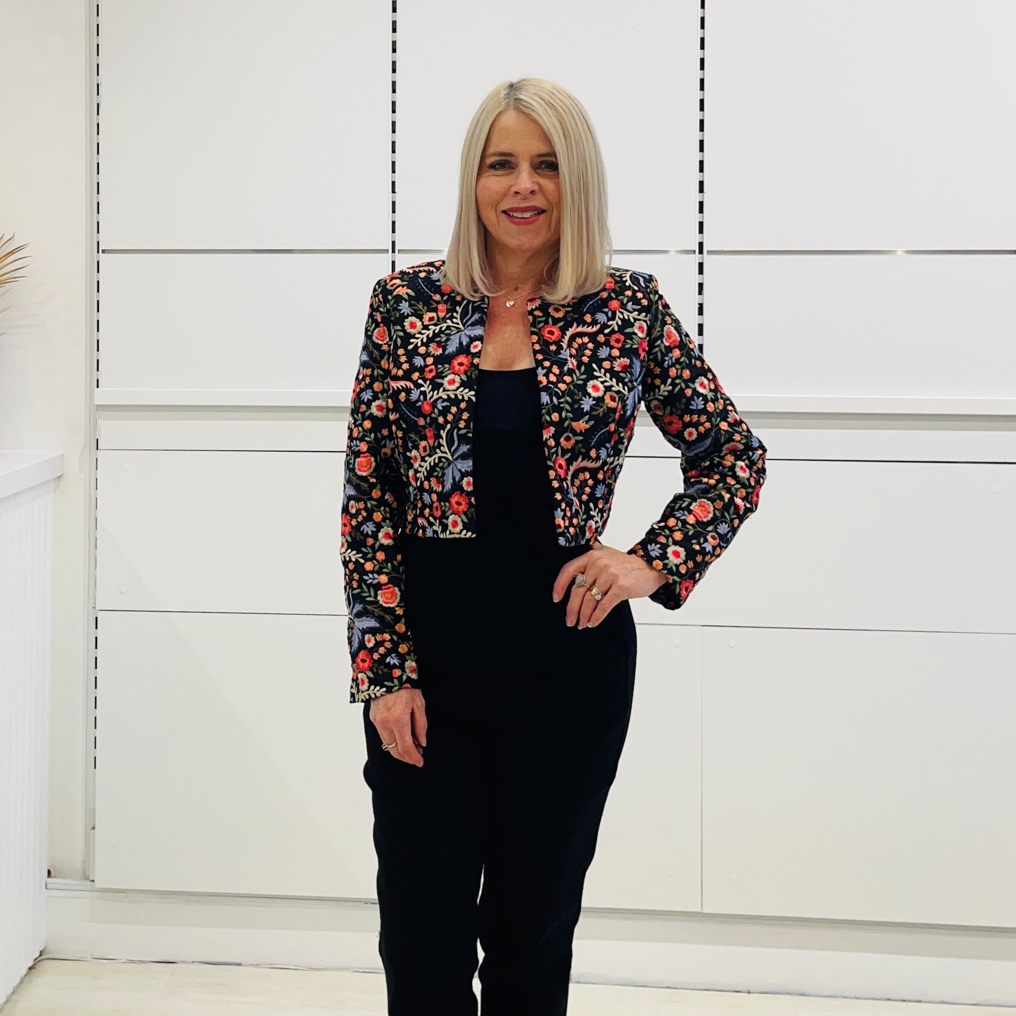 Black short, bolero jacket with all over multi coloured embroidery.