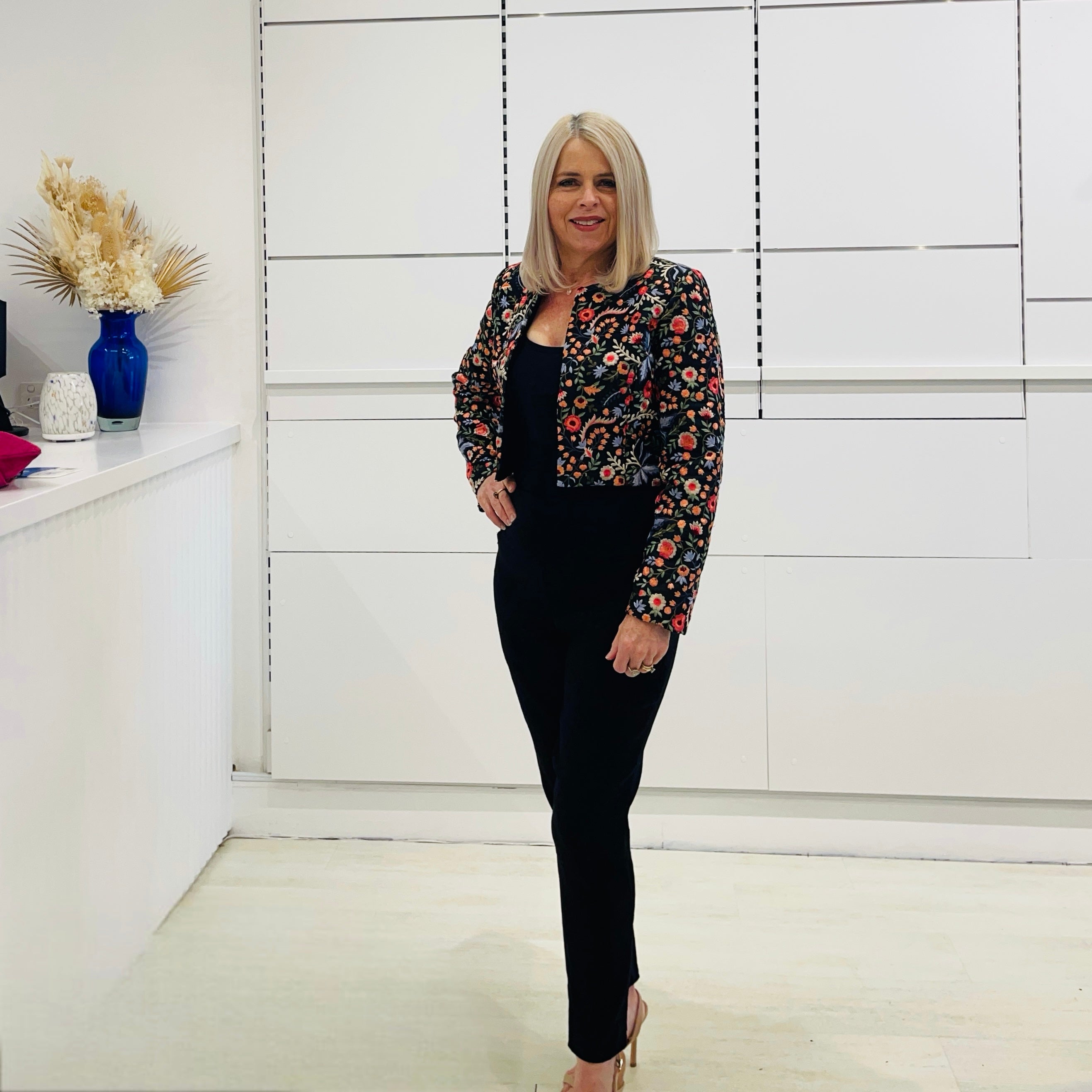 Black short, bolero jacket with all over multi coloured embroidery.