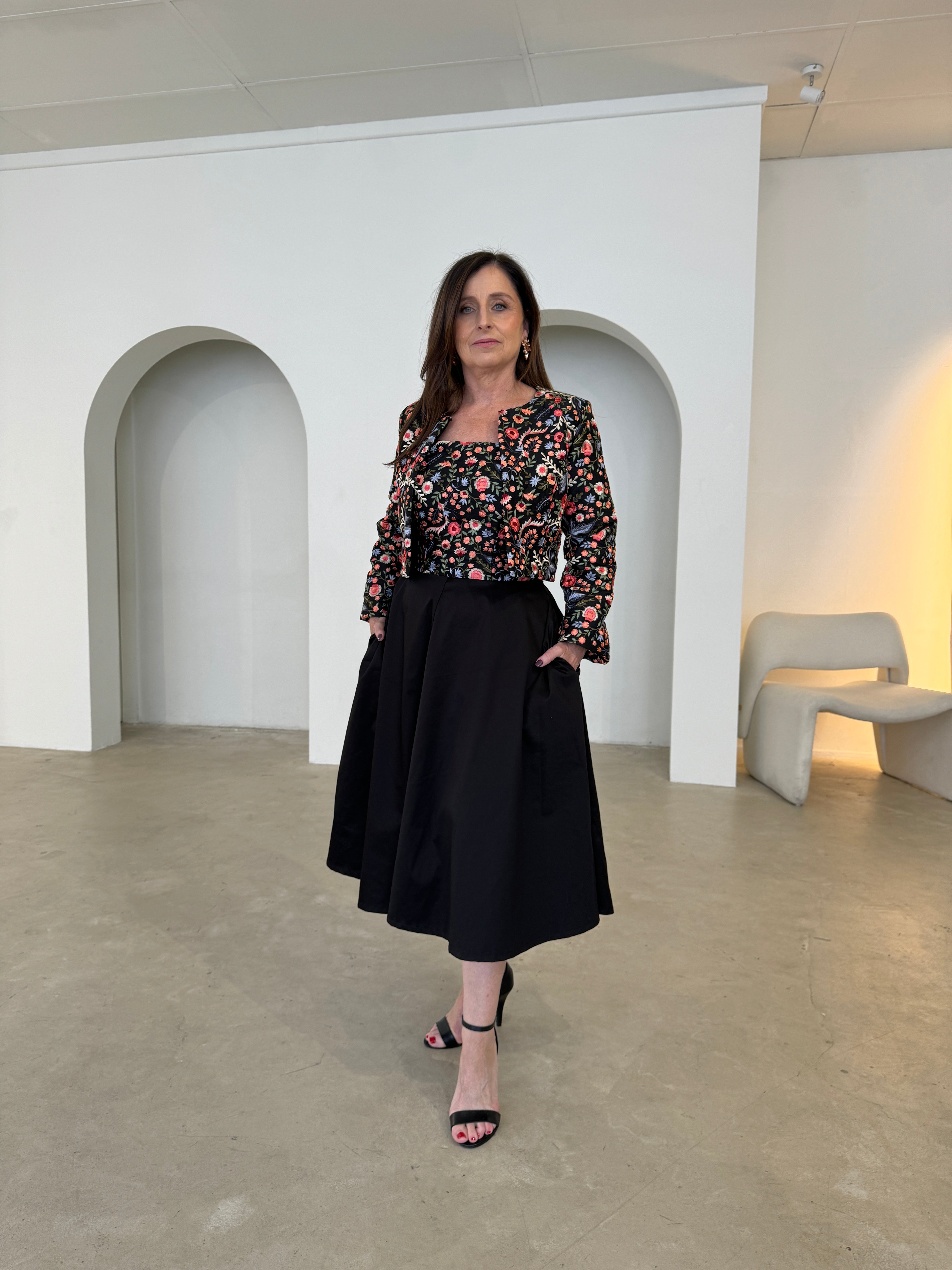 Black short, bolero jacket with all over multi coloured embroidery.With matching strapless embroidered bodice dress, with pockets .