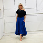 Royal blue,long, maxi,dipped hemline, flat fitted waistband ,skirt with pockets. Worn with black off the shoulder top