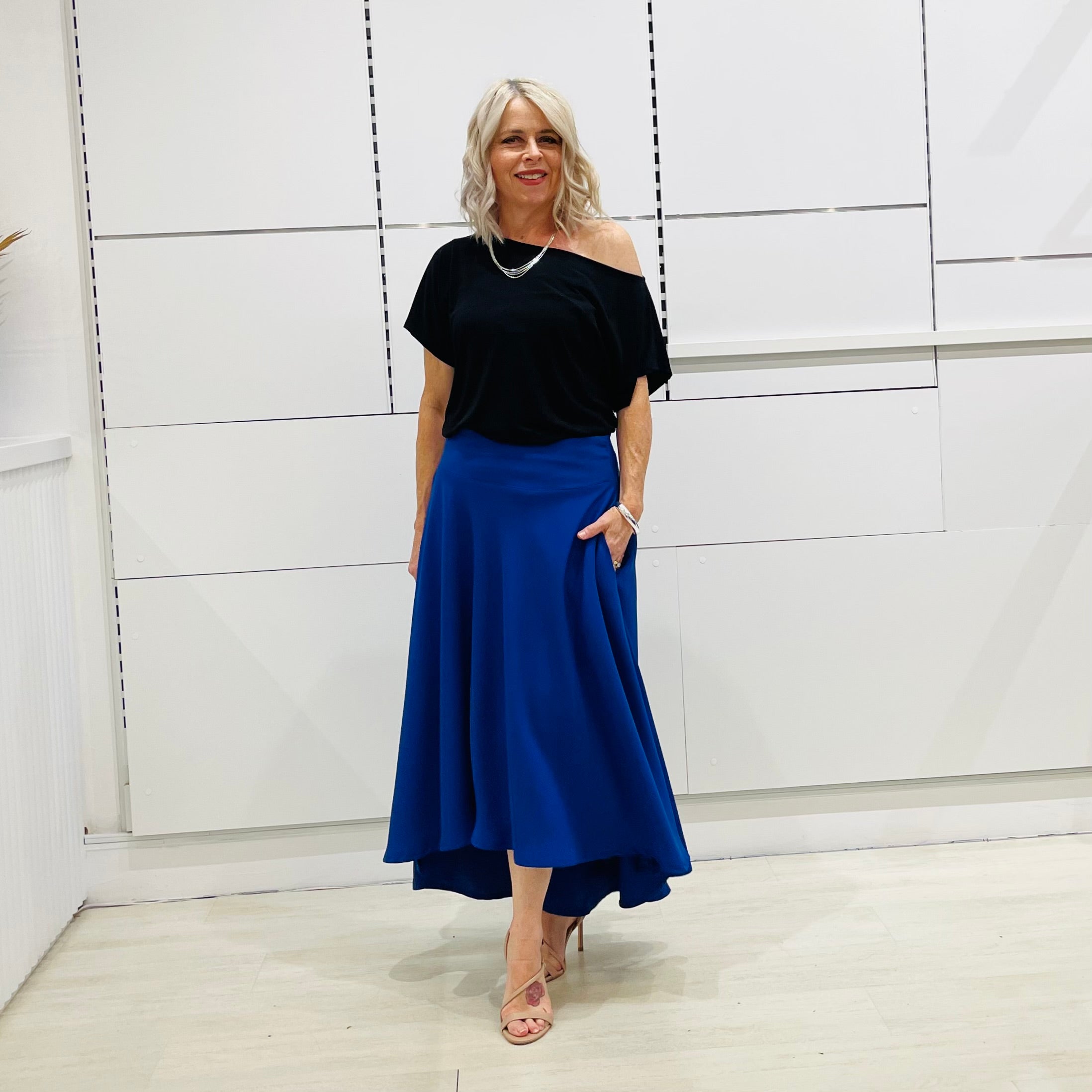 Royal blue,long, maxi,dipped hemline, flat fitted waistband ,skirt with pockets. Worn with black off the shoulder top