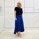 Royal blue,long, maxi,dipped hemline, flat fitted waistband ,skirt with pockets. Worn with black ff the shoulder top
