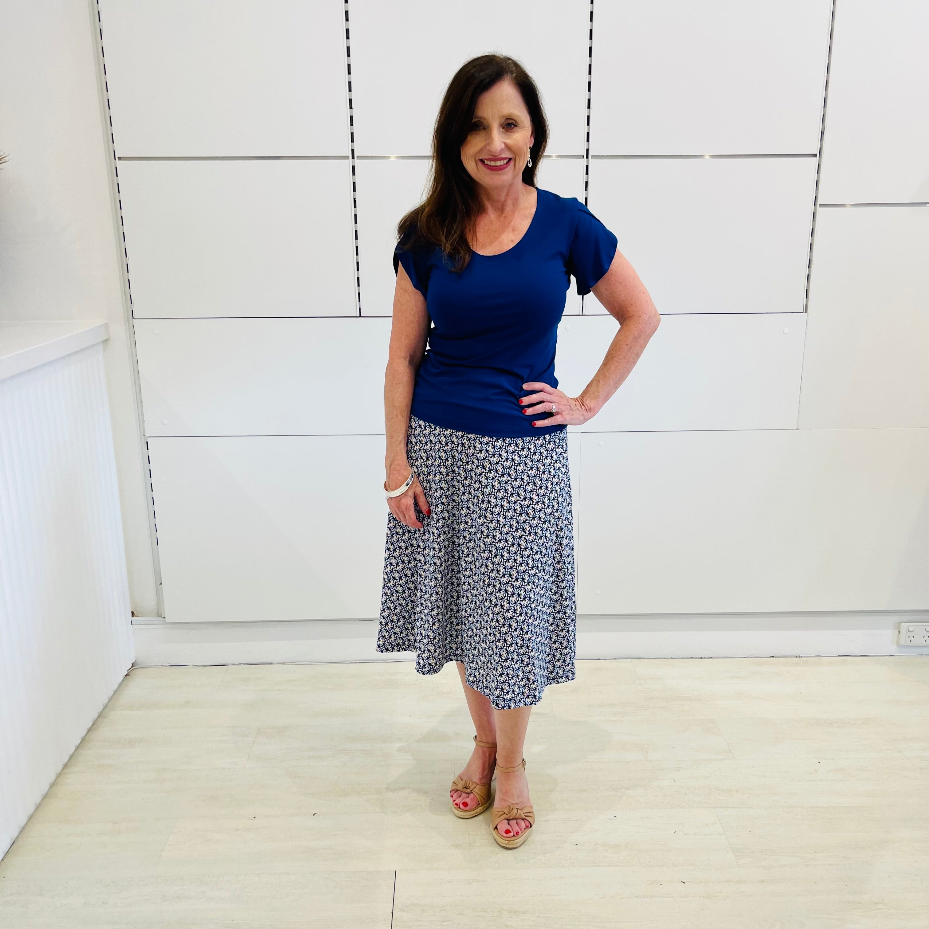 Blue midi length, stretch, a-line skirt, with blue, cross over, short sleeve, scoop neckline, fitted top