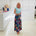 Woman wearing blue t shirt with long floral skirt.
