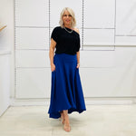Royal blue,long, maxi,dipped hemline, flat fitted waistband ,skirt with pockets. Worn with black off the shoulder top. Soft, floaty skirt with drape.