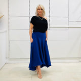 Royal blue,long, maxi,dipped hemline, flat fitted waistband ,skirt with pockets. Worn with black off the shoulder top. Soft, floaty skirt with drape.