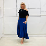 Royal blue,long, maxi,dipped hemline, flat fitted waistband ,skirt with pockets. Worn with black off the shoulder top