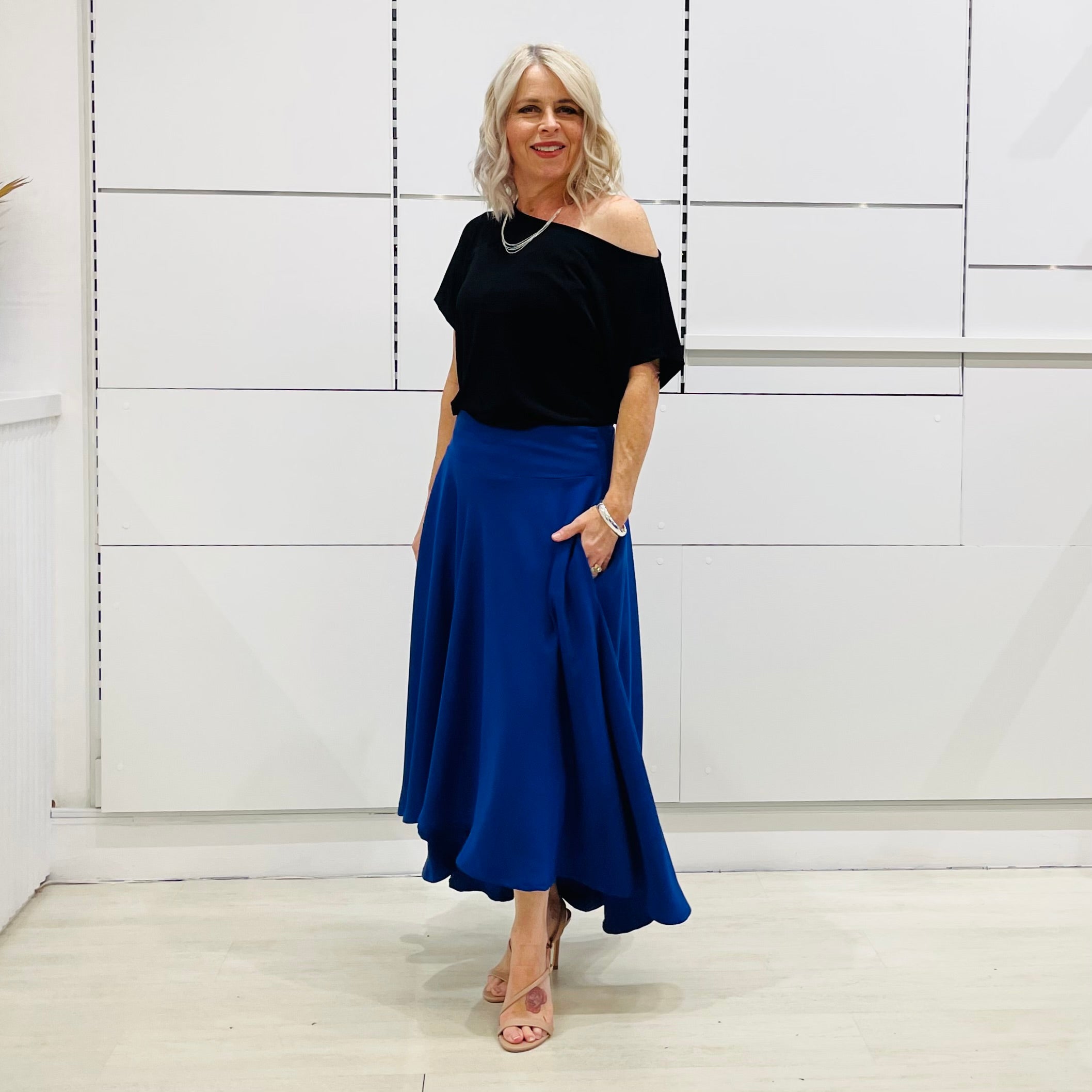 Royal blue,long, maxi,dipped hemline, flat fitted waistband ,skirt with pockets. Worn with black off the shoulder top