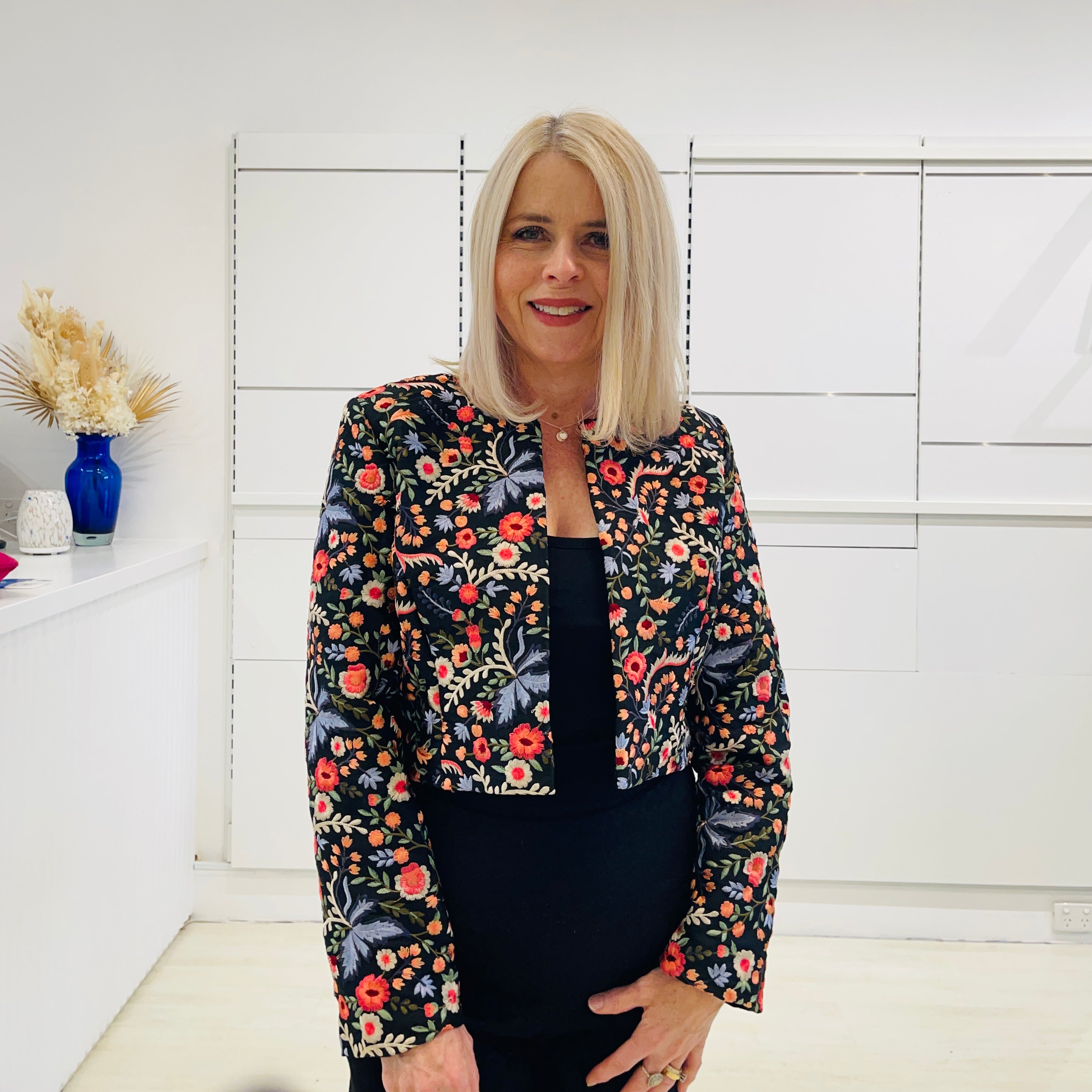 Black bolero, short jacket with all over multi coloured embroidery.