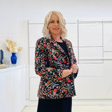 Black silk, with floral embroidery, collar, lapels, 3 button front closure, with pockets jacket. Worn with dressy straight black dress with side seam splits.