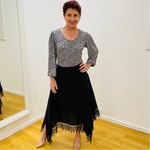 Black linen skirt, with lace detail on waistband and around the handkerchief, uneven, hemline. With black & white floral pattern, scoop neck, 3/4 length, gathered sleeve blouse.