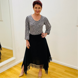 Black linen skirt, with lace detail on waistband and around the handkerchief, uneven, hemline. With black & white floral pattern, scoop neck, 3/4 length, gathered sleeve blouse.