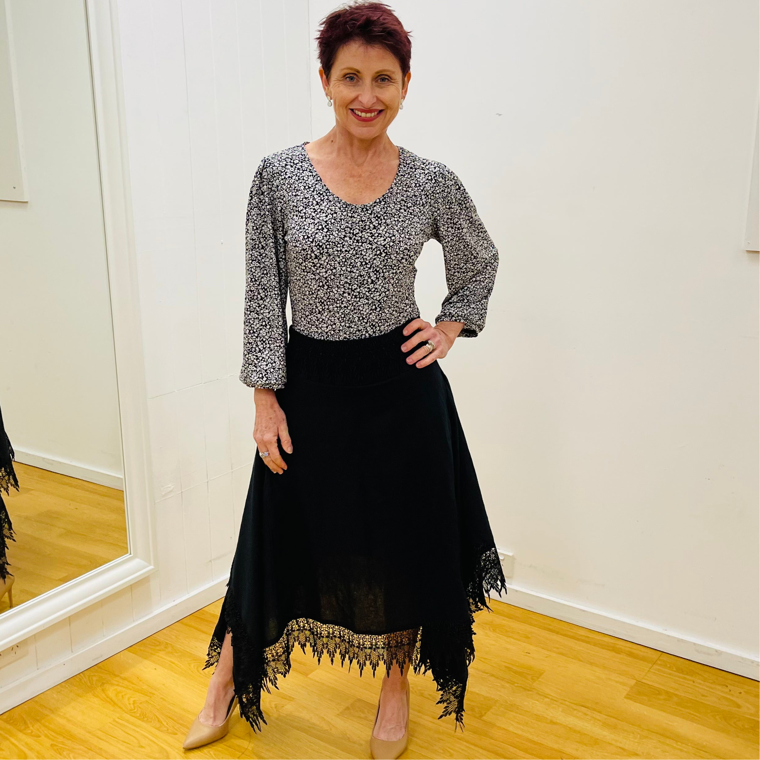 Black linen skirt, with lace detail on waistband and around the handkerchief, uneven, hemline. With black & white floral pattern, scoop neck, 3/4 length, gathered sleeve blouse.