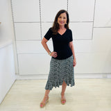 Green,black and white print, stretch, slight a-line skirt, with small ruffle on hemline. Worn with black bamboo, short sleeve top.