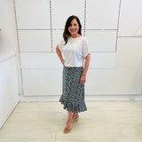 Green,black and white print, stretch, slight a-line skirt, with small ruffle on hemline. Worn with white bamboo, short sleeve, relaxed fit  top.