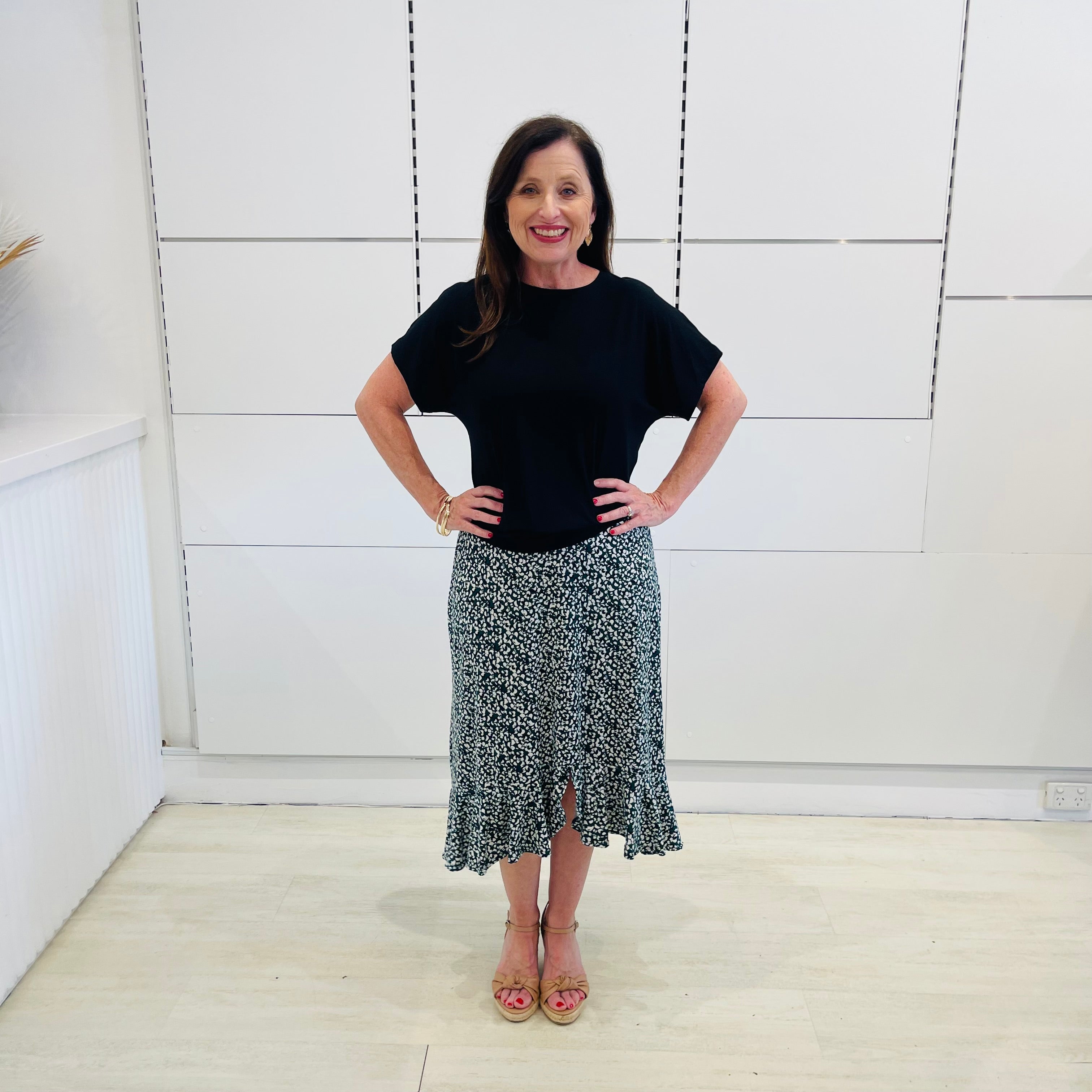 Green,black and white print, stretch, slight a-line skirt, with small ruffle on hemline, & black bamboo, short sleeve, scoop neckline, relaxed fit top