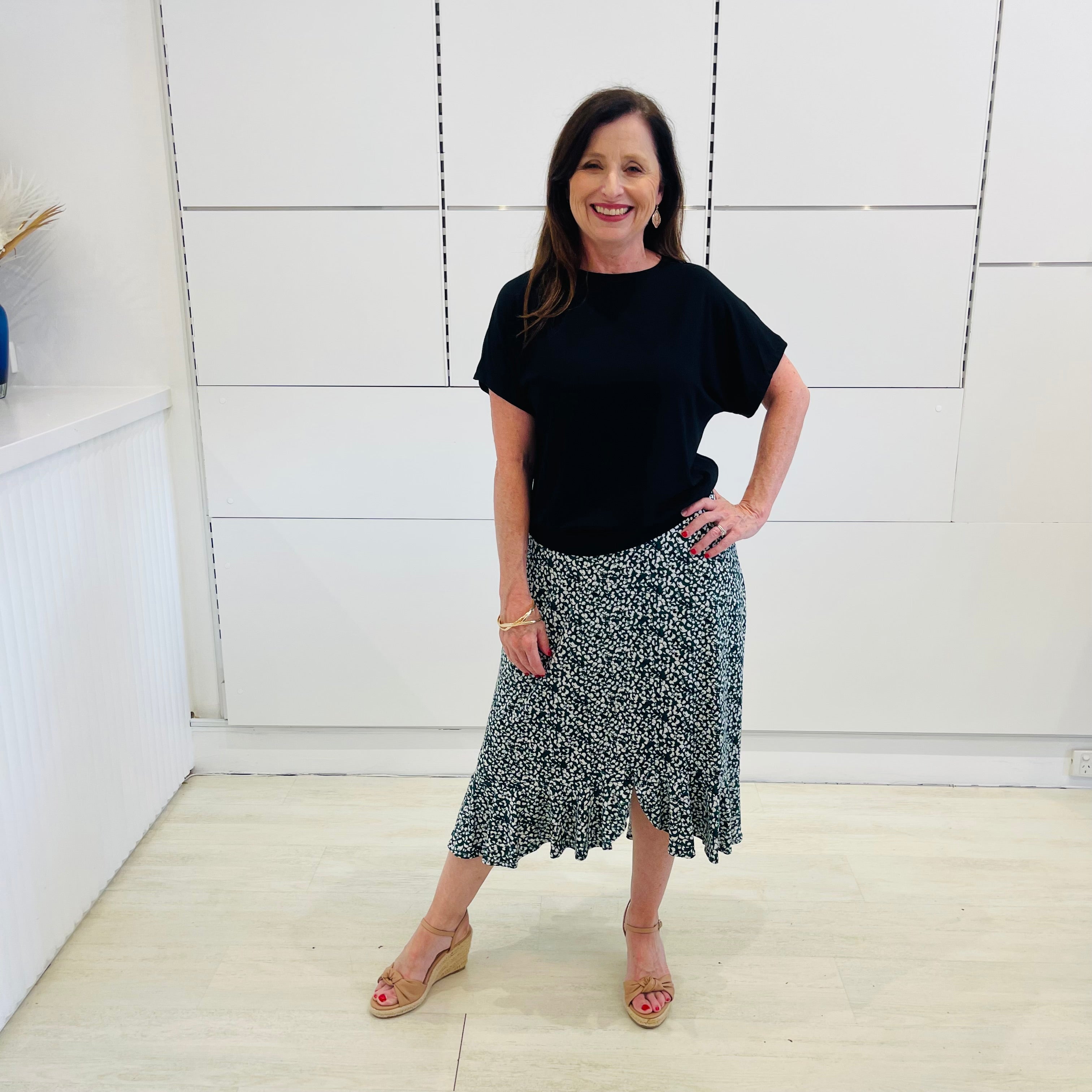 Green,black and white print, stretch, slight a-line skirt, with small ruffle on hemline, & black bamboo, short sleeve, scoop neckline, relaxed fit top