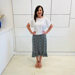 Green,black and white print, stretch, slight a-line skirt, with small ruffle on hemline. White bamboo, short sleeve, scoop neckline, relaxed fit top