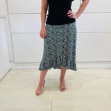 Green,black and white print, stretch, slight a-line skirt, with small ruffle on hemline. Worn with black bamboo, short sleeve top.