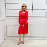 Bright watermelon pink Penelope dress on model- vibrant colour, stretch dress, with feminine silhouette, long sleeve, a-line skirt and keyhole neckline.