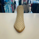 Intricate cut out design on cream colored man made leather ankle boots. Low 4cm heel. Zipper opening on side.