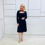 Penelope dress in deep navy blue, worn by model- elegant long sleeve design, knee length, with modern neckline.