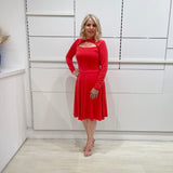 Bright watermelon pink Penelope dress on model- vibrant colour, stretch dress, with feminine silhouette, long sleeve, a-line skirt and keyhole neckline.