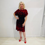 Black base colour dress with red floral border print on neckline and hemline. Short sleeve & knee length dress.
