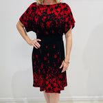 Black base colour dress with red floral border print on neckline and hemline. Short sleeve & knee length dress.