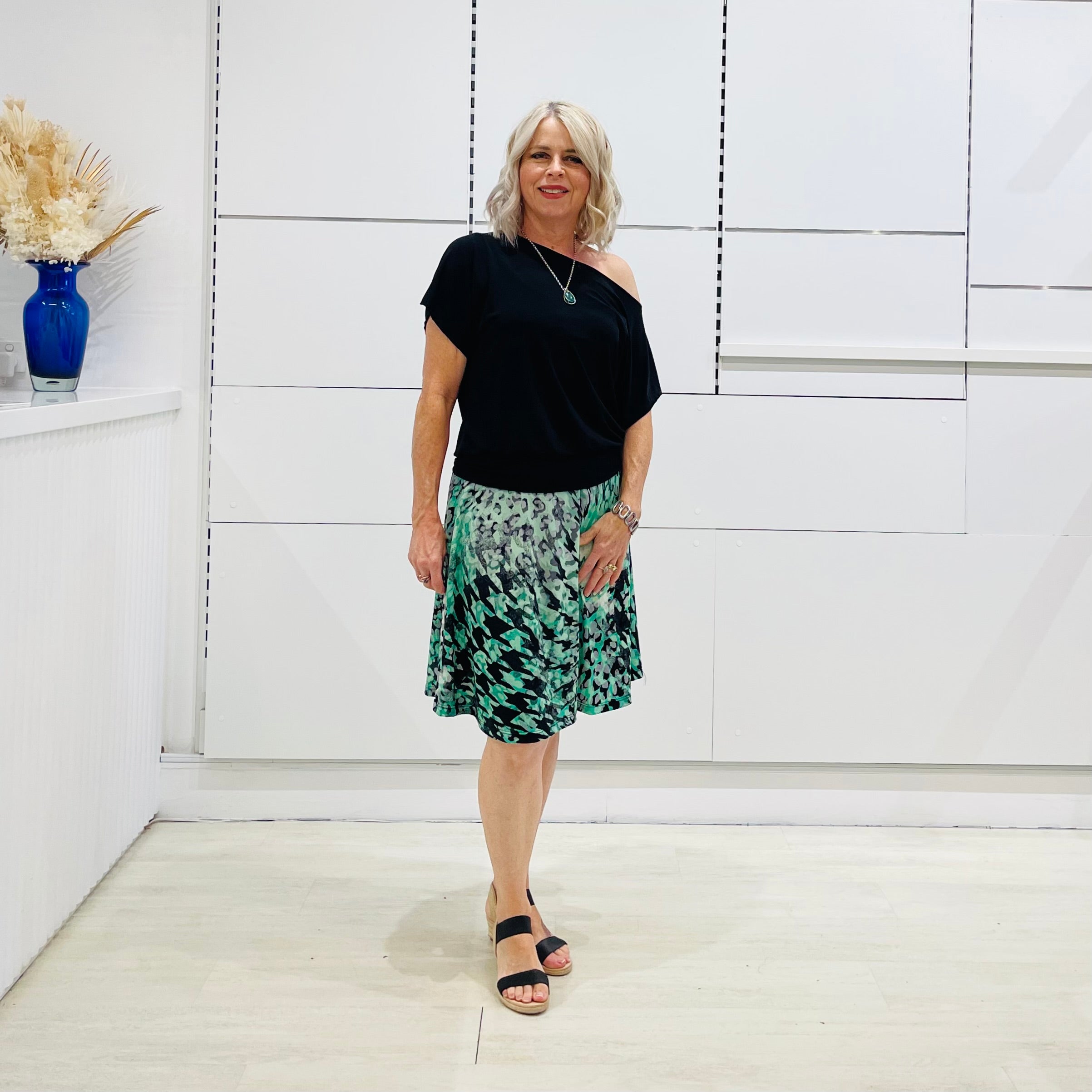 Black, off the shoulder, asymmetrical neckline, relaxed fit top.