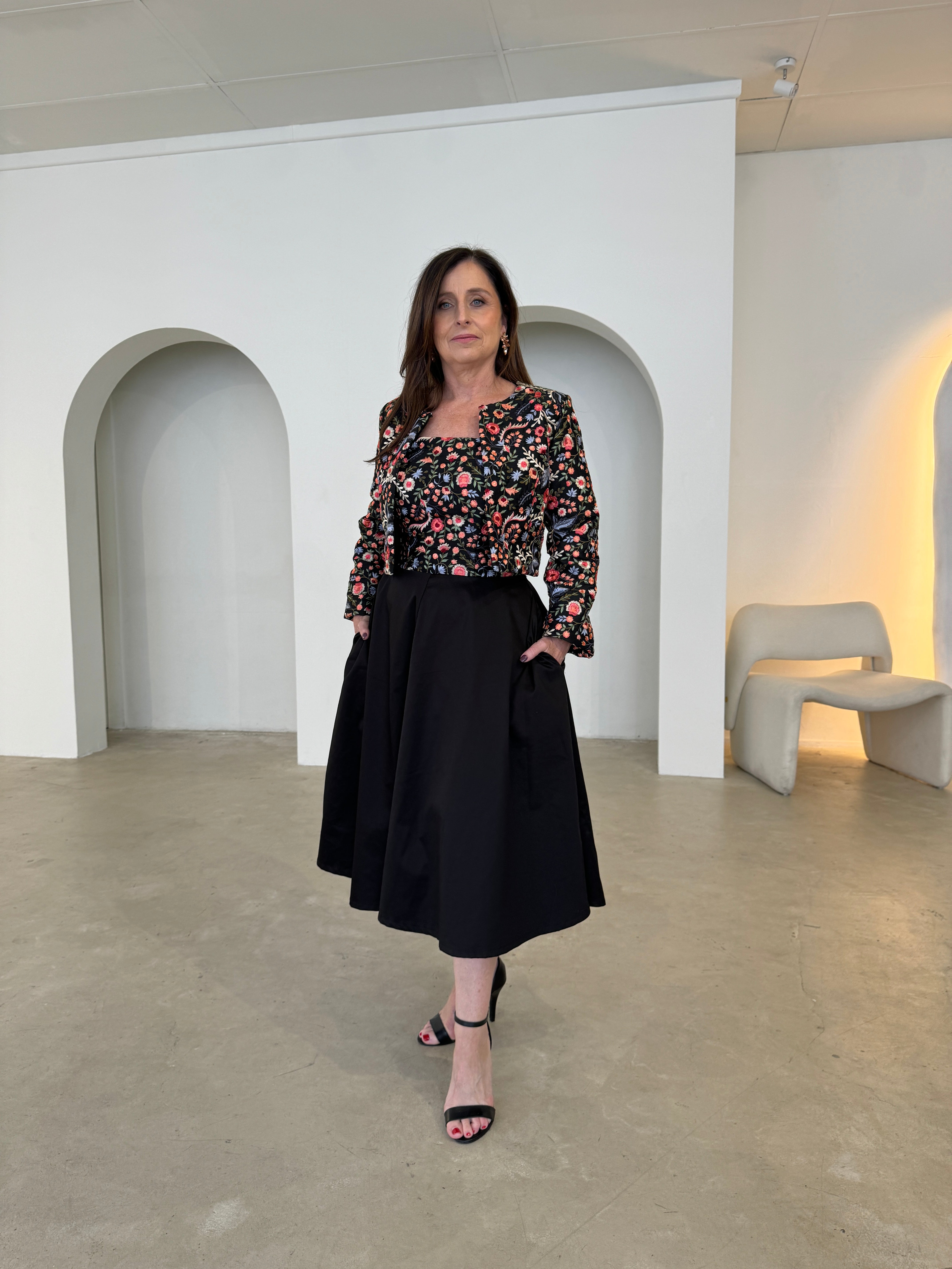 Black short, bolero jacket with all over multi coloured embroidery.With matching strapless embroidered bodice dress, with pockets .