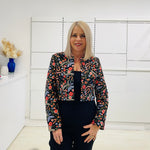 Black bolero, short jacket with all over multi coloured embroidery.