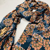 Navy background with a frangipani print chiffon scarf