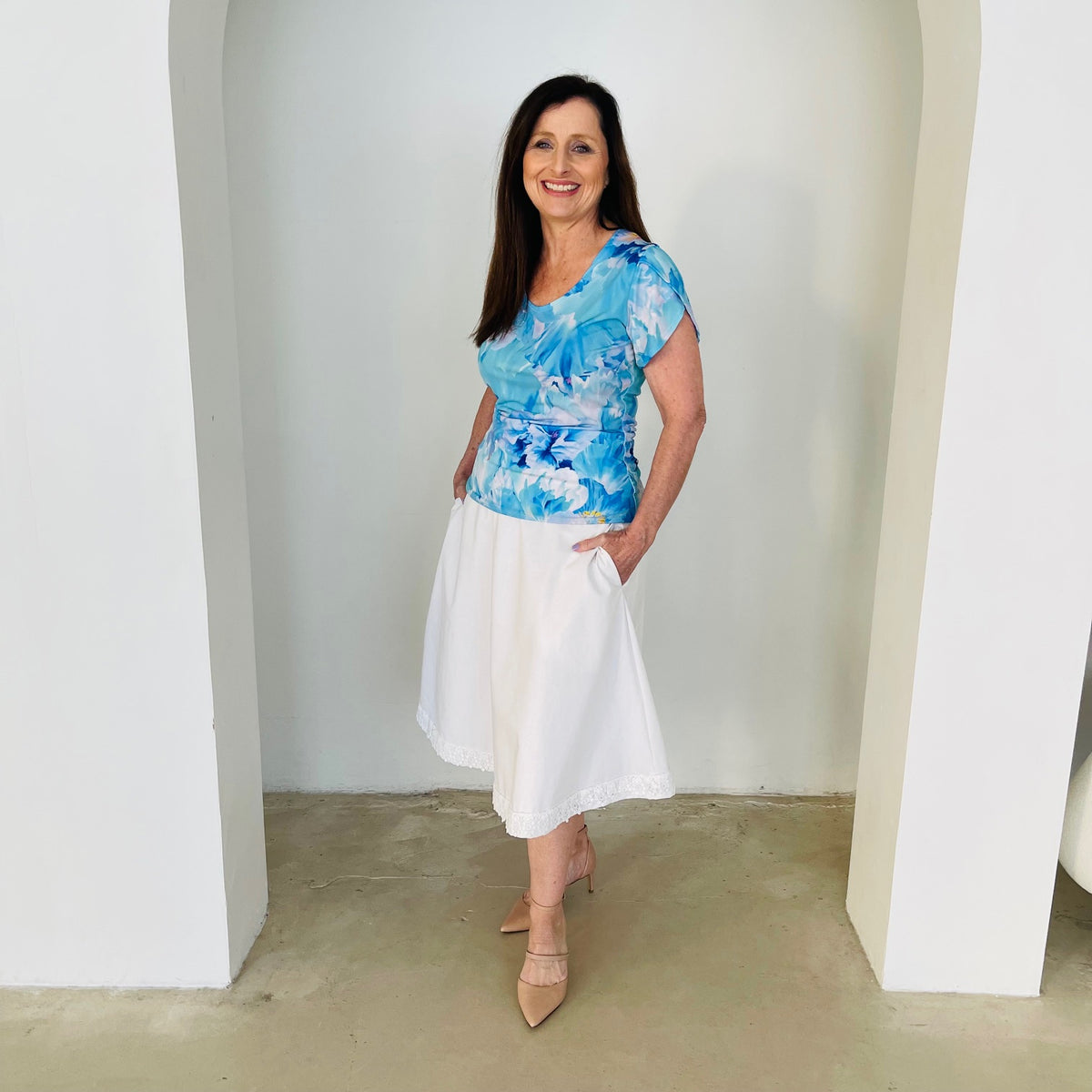 Blue floral, round neckline, short cross over sleeve top with white skirt.