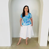 Blue floral, round neckline, short cross over sleeve top with white skirt.