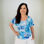 Blue floral, round neckline, short wave sleeve top with white skirt.